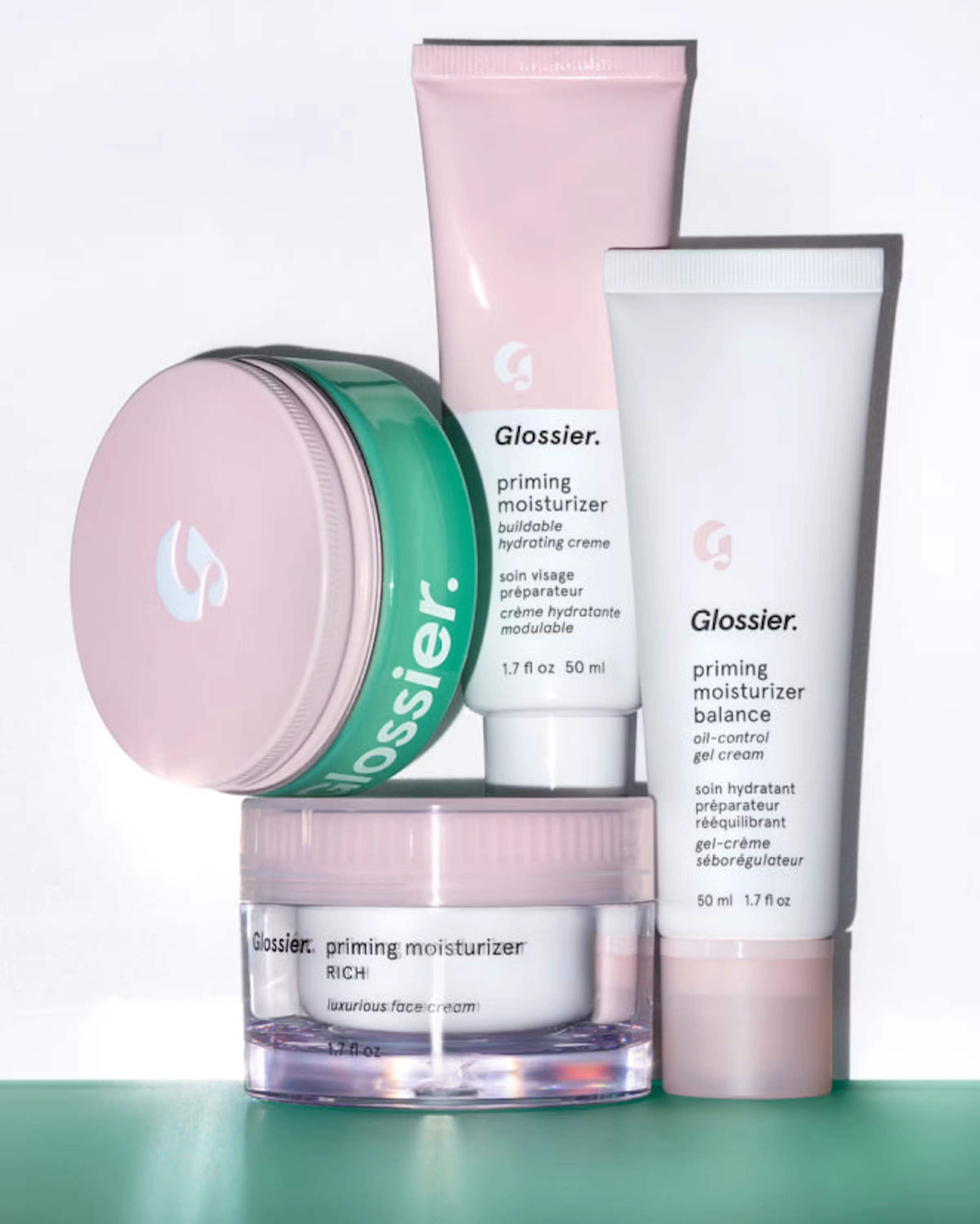 Three skincare products stacked on a green block, from the home page highlight card