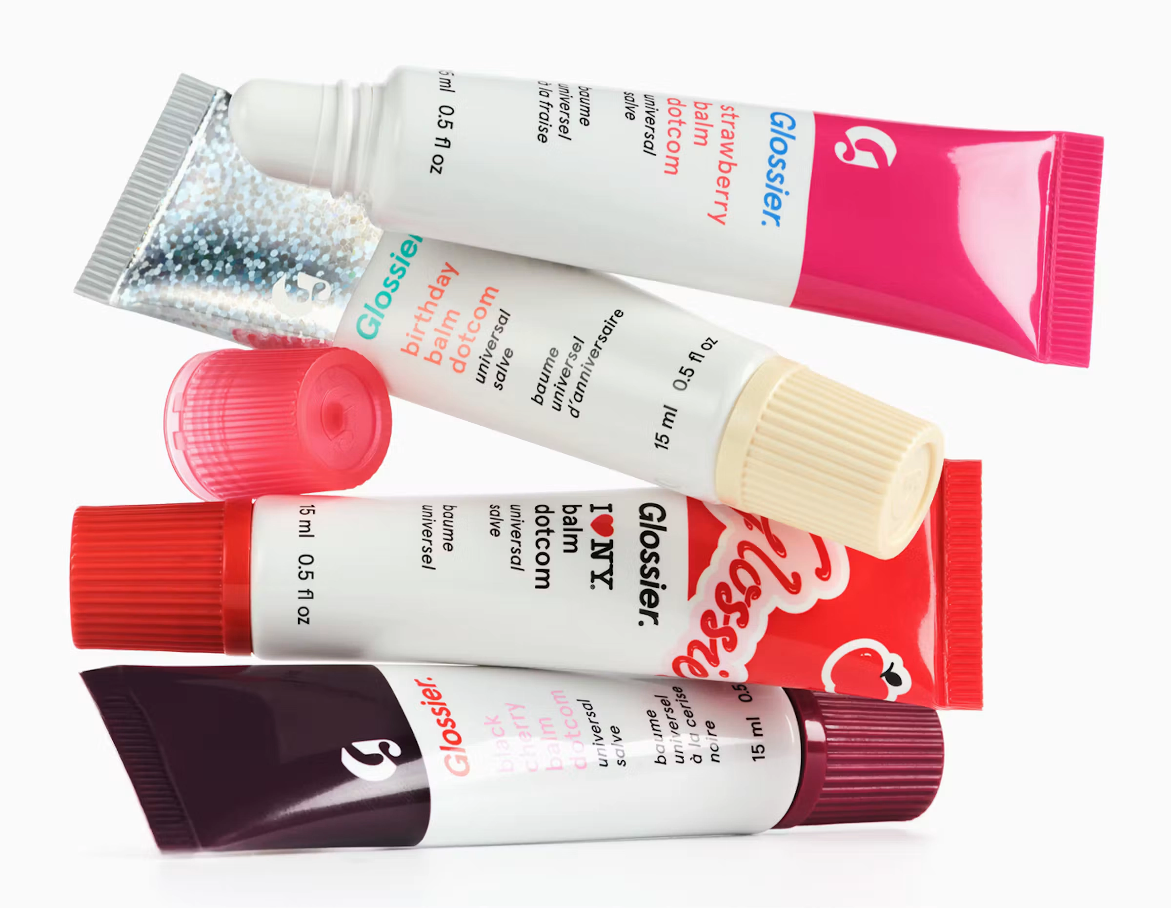 Tubes of Glossier balm and Cloud Paint stacked and squeezed out