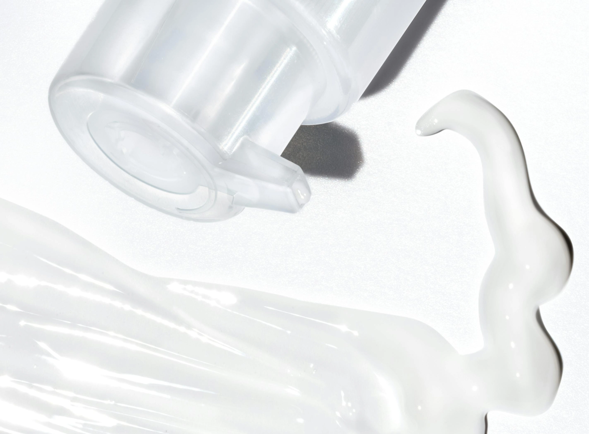 Clear skincare gel texture photographed close up on white