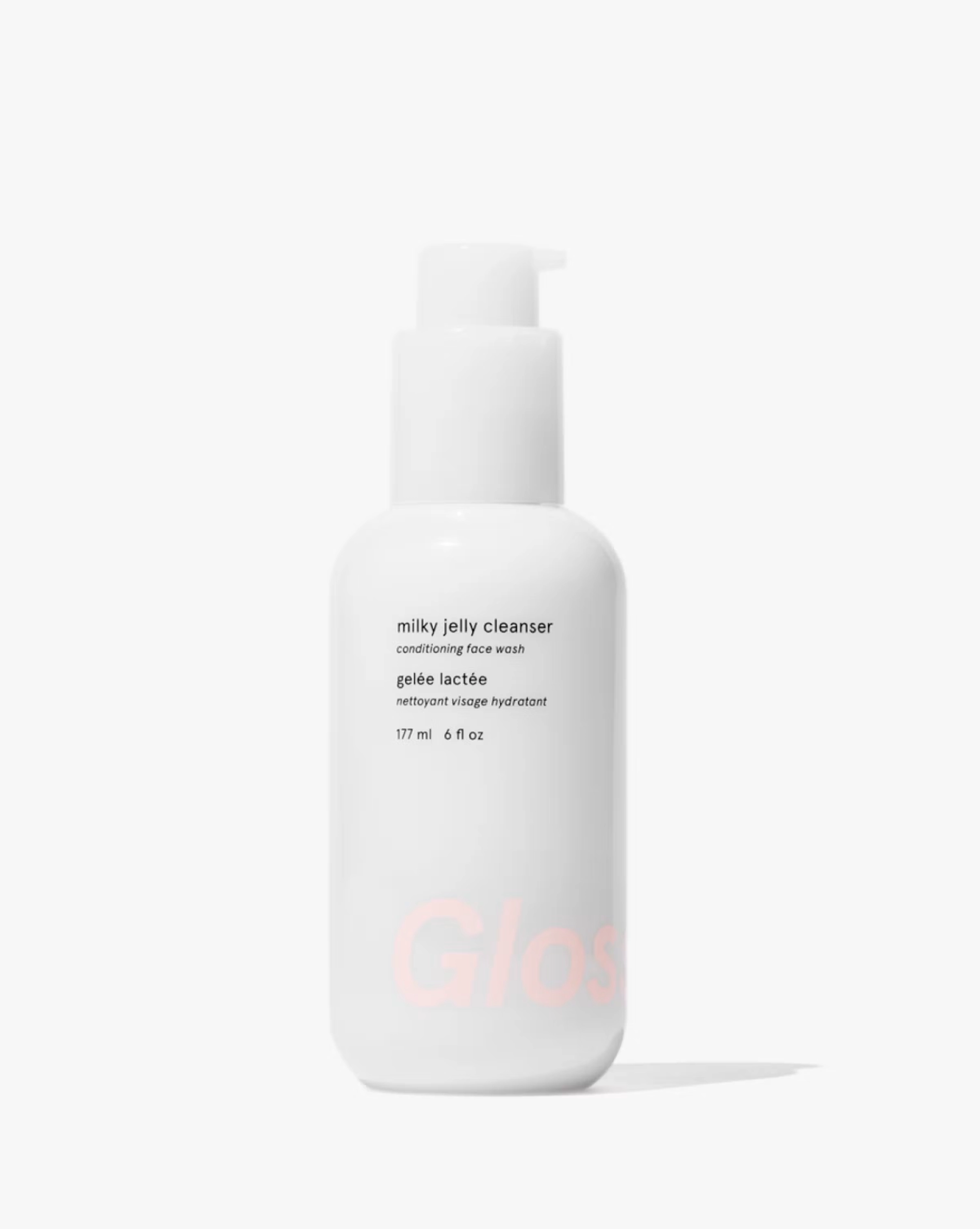 Milky jelly cleanser bottle on a pale background