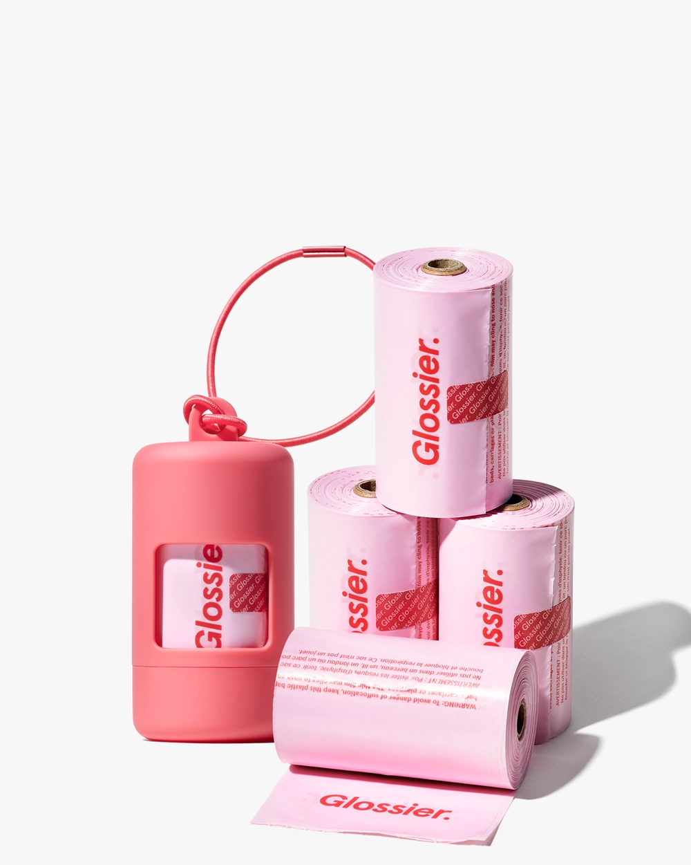 The Curbside Set: a pink dispenser with stacked pink waste bag rolls